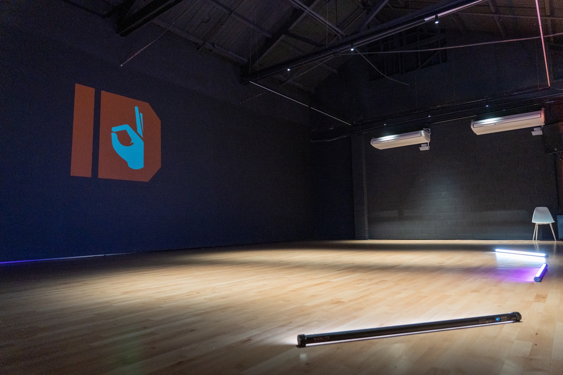 Open ID HUB studio floor with branding projected onto the back wall